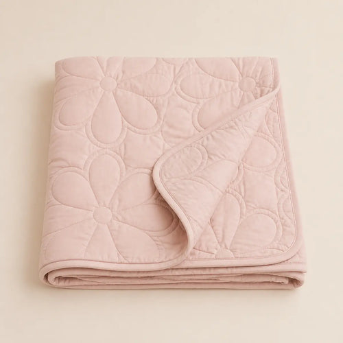 Blush Petal Quilted Blanket arranged as a clean baby shower product photo
