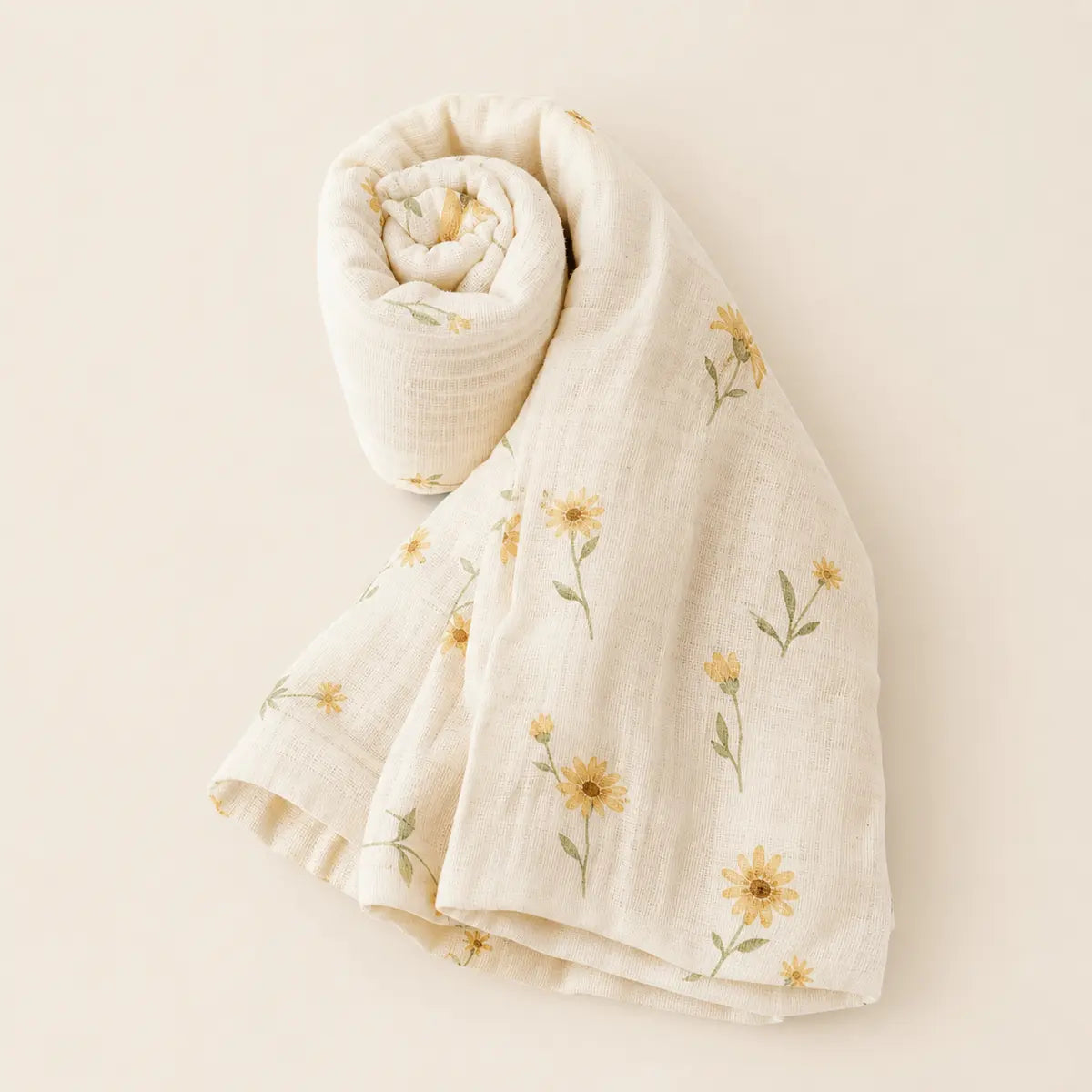 Daisy Daydream Swaddle arranged as a clean baby shower product photo