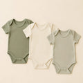Little Sprout Bodysuit Trio arranged as a clean baby shower product photo