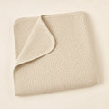 Oatmeal Waffle Stroller Blanket arranged as a clean baby shower product photo