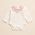 Petal Collar Bodysuit arranged as a clean baby shower product photo