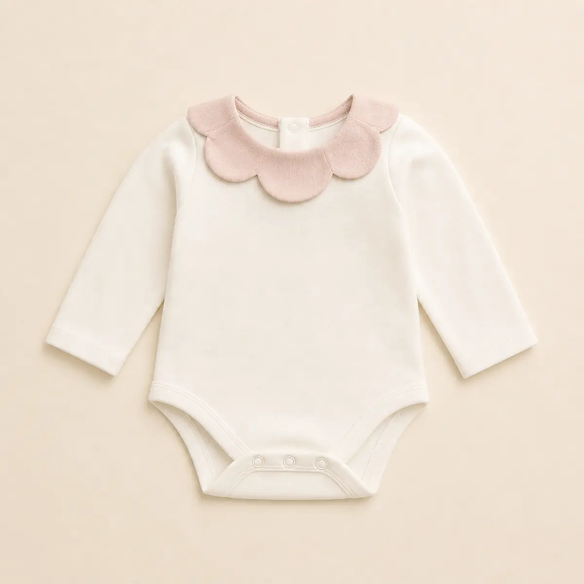 Petal Collar Bodysuit arranged as a clean baby shower product photo