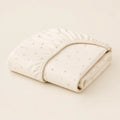 Starry Crib Sheet arranged as a clean baby shower product photo