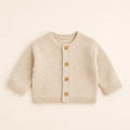 Sunday Knit Cardigan arranged as a clean baby shower product photo