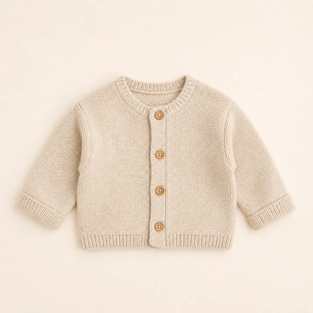 Sunday Knit Cardigan arranged as a clean baby shower product photo